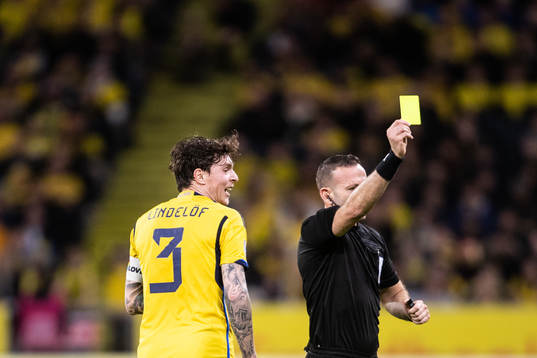Victor Nilsson Lindelöf of Sweden receives a yellow card