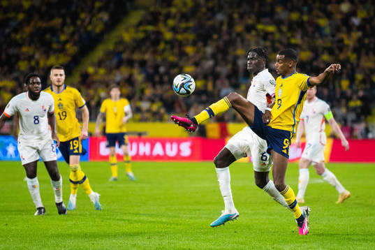 Amadou Onana of Belgium and Alexander Isak of Sweden