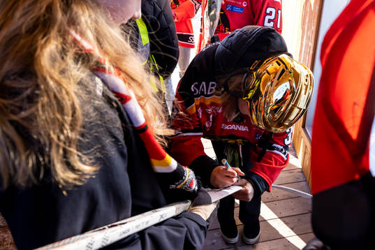 Frida Axell  skriver autograf på klubba