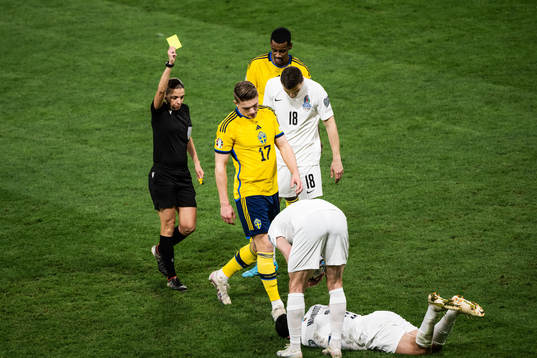 Viktor Gyökeres of Sweden receives a yellow card by