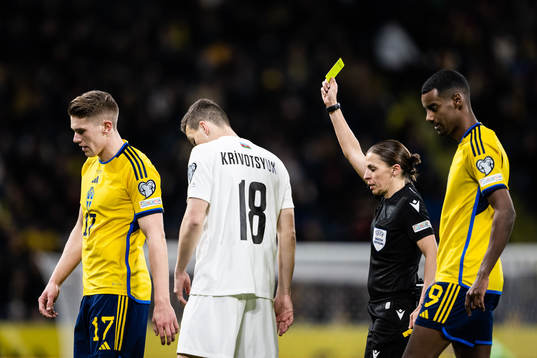Viktor Gyökeres of Sweden receives a yellow card by