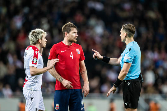 Stefan Strandberg of Norway and Referee Andris Treimanis