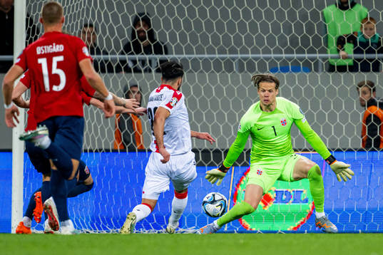 Georges Mikautadze of Georgia scores 1-1 behind goalkeeper