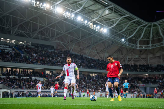 Guram Kashia of Georgia and Mohamed Elyounoussi of Norway