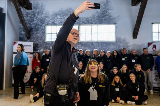 Photographers takes a selfie with the players and leaders