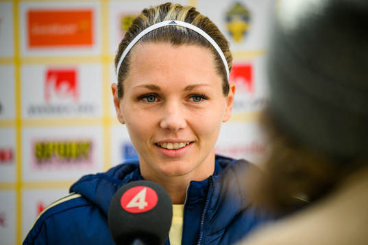 Goalkeeper Jennifer Falk is interviewed by the media
