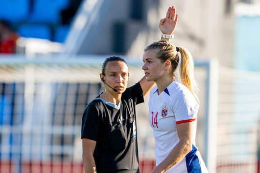 Referee Ivana Projkovska and Ada Hegerberg of Norway