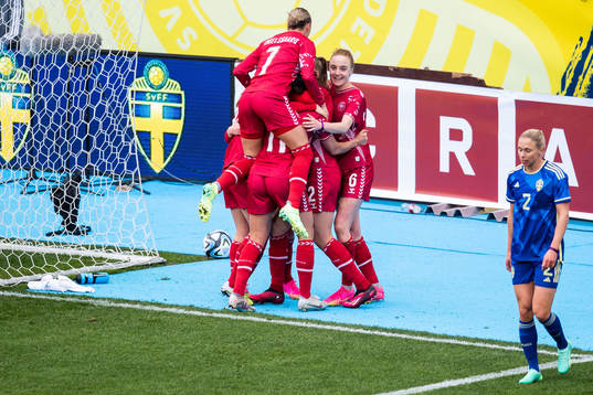 Players of Denmark celebrate and Jonna Andersson of Sweden