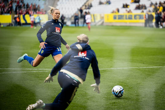 Fridolina Rolfö and goalkeeper Jennifer Falk of Sweden
