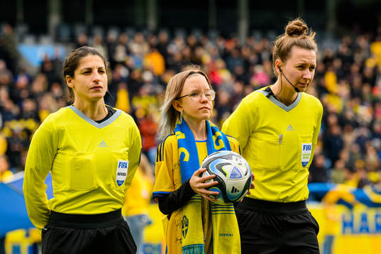Referee Riem Hussein and a mascot