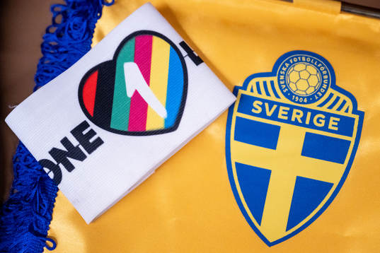 The One Love captains’ armband next to the logo of the