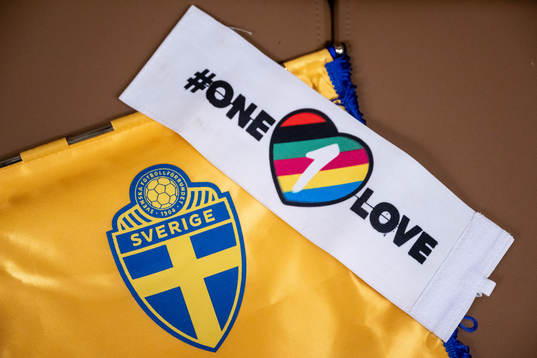 The One Love captains’ armband next to the logo of the