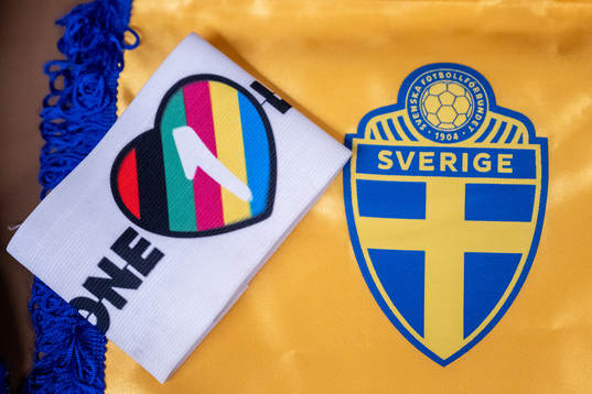The One Love captains’ armband next to the logo of the