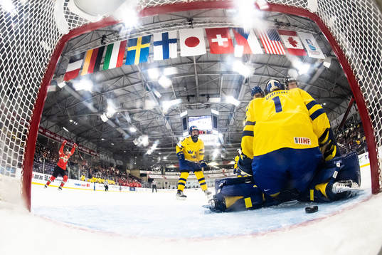 Alexandra Huszak of Hungary scores 2-2 behind goaltender