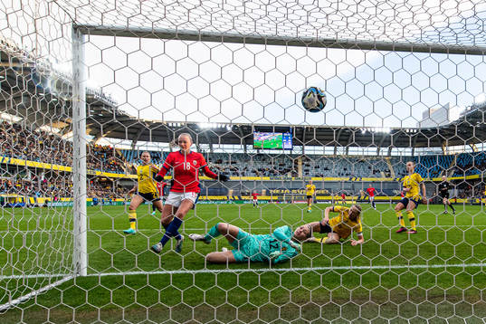 Frida Maanum of Norway score 1-1 behind goalkeeper Jennifer