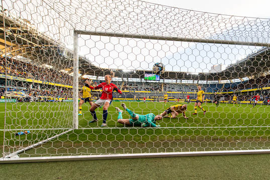 Frida Maanum of Norway score 1-1 behind goalkeeper Jennifer