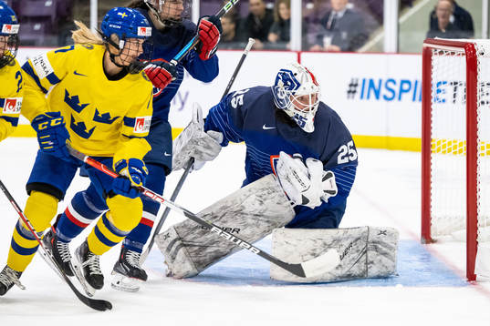 Sofie Lundin of Sweden and goaltender Caroline Lambert of