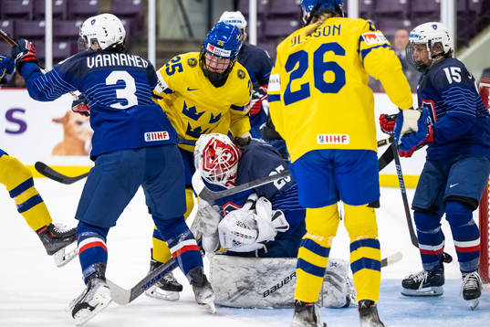 Lina Ljungblom of Sweden and goaltender Caroline Lambert of