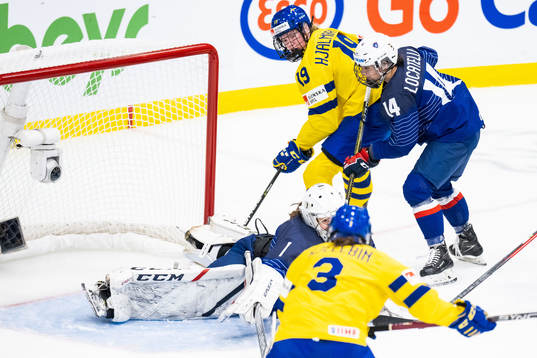 Sara Hjalmarsson of Sweden and goaltender Caroline Lambert