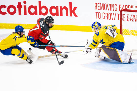 Mira Jungåker and goaltender Emma Söderberg of Sweden and