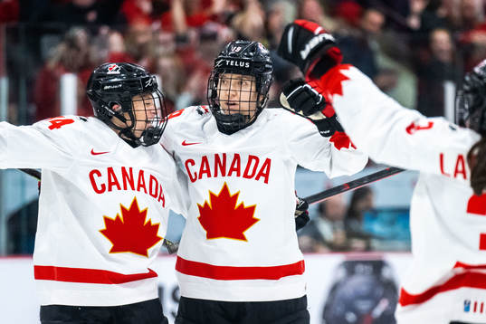 Renata Fast and Brianne Jenner of Canada celebrate scoring