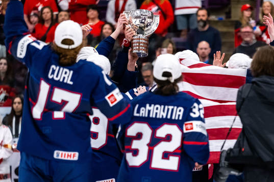 Players of USA celebrate winning the 2023 IIHF Women's