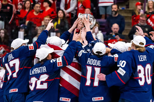 Players of USA celebrate winning the 2023 IIHF Women's