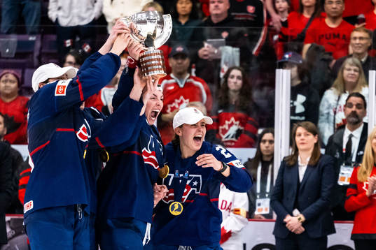 Players of USA celebrate winning the 2023 IIHF Women's