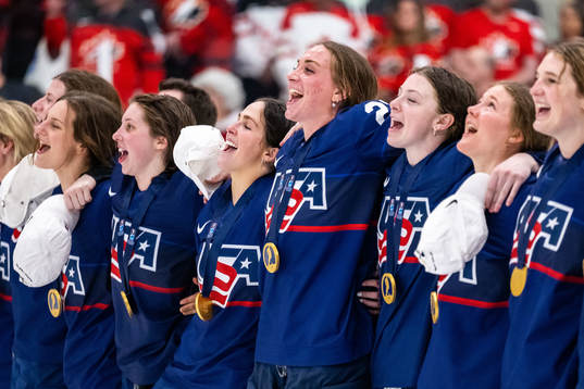 Players of USA celebrate winning the 2023 IIHF Women's
