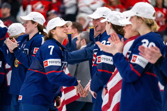 Players of USA celebrate winning the 2023 IIHF Women's