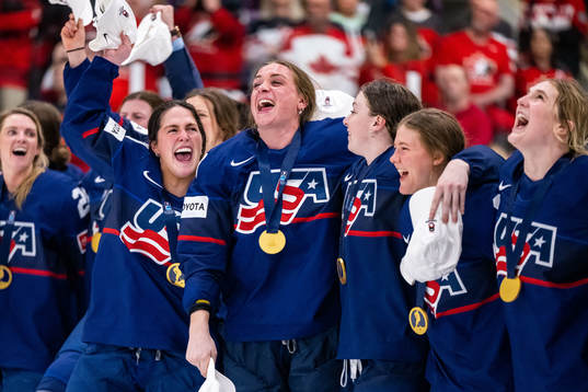 Players of USA celebrate winning the 2023 IIHF Women's