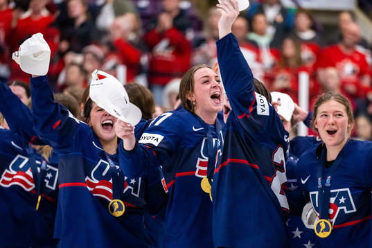 Players of USA celebrate winning the 2023 IIHF Women's