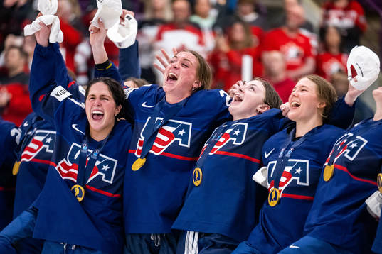 Players of USA celebrate winning the 2023 IIHF Women's