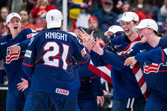 Players of USA celebrate winning the 2023 IIHF Women's