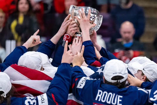 Players of USA celebrate winning the 2023 IIHF Women's