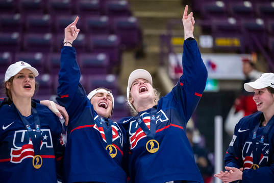 Players of USA celebrate winning the 2023 IIHF Women's