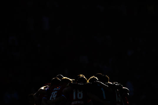 Players of Brann gather in a circle