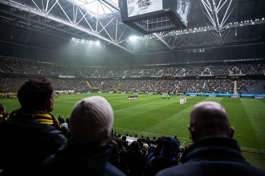 Vy från läktaren när AIKs och Sirius spelare står