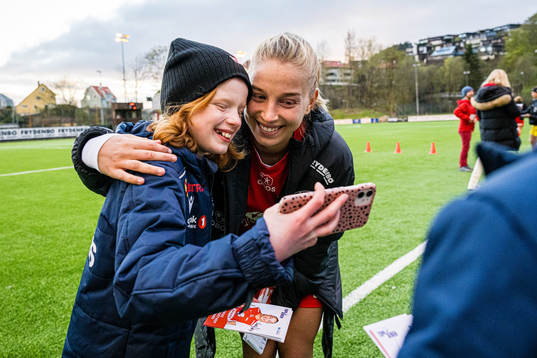 Rikke Bogetveit Nygard of Brann taking a selfie with a fan