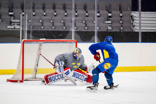 Goaltender Lars Johansson and Lucas Raymond of Sweden at a