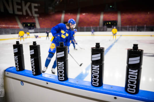 Nocco water bottles at rinkside at a practice session of