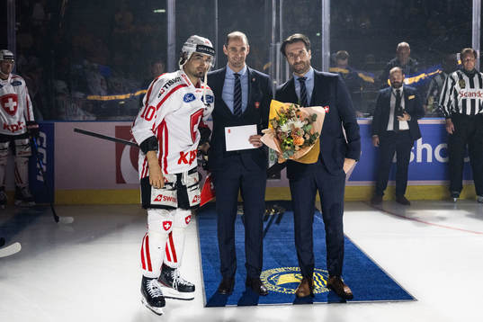 Andres Ambühl of Switzerland receives an award