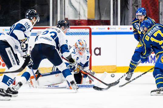 Nikolas Matinpalo and goaltender Christian Heljanko of
