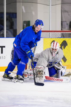 Jonathan Pudas and goaltender Jacob Johansson of Sweden at