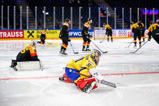 Mathias Niederbergerof Germany and goaltender Lars