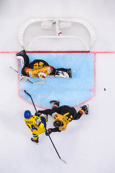 Oscar Lindberg of Sweden challenges goaltender Mathias