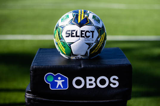 En matchboll i en bollhållare med reklam för Obos