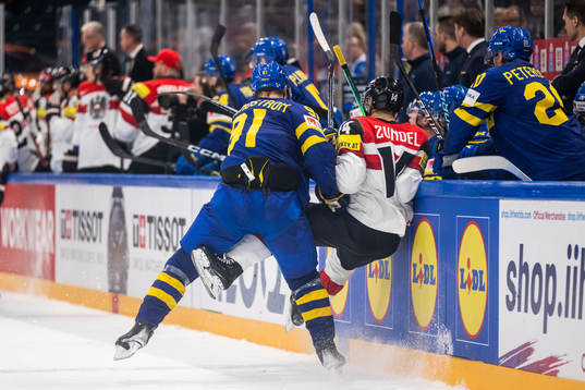 Carl Grundström of Sweden tackles Kilian Zundel of Austria
