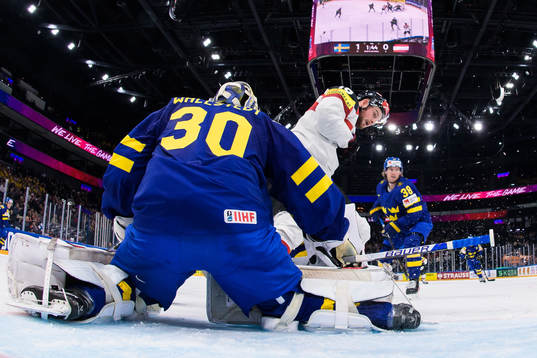 Goaltender Jesper Wallstedt of Sweden is being challenged