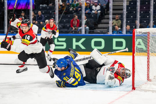 Kilian Zundel and goaltender Bernhard Starkbaum of Austria